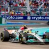 A Formula 1 car drives past the logo of their perfect sponsorship match Crypto.com